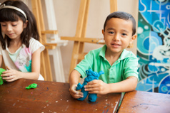 boy playing with clay